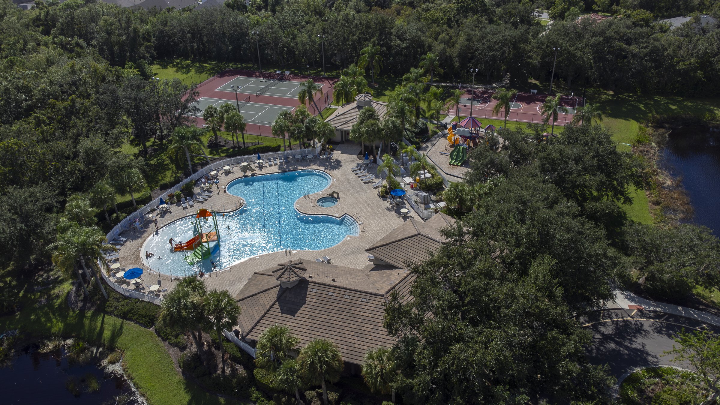 Community pool, playground, and amenity center aerial — Sarasota drone photography