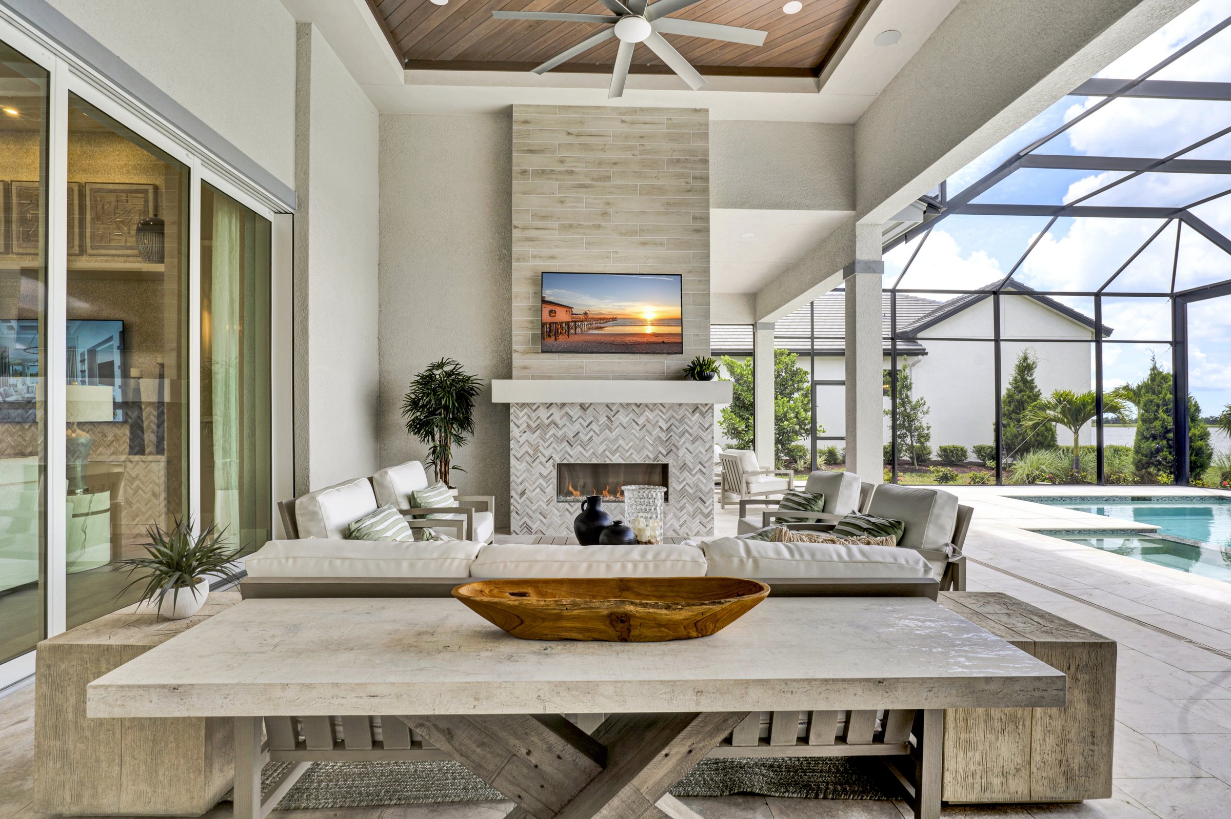 Outdoor living suite with fireplace and pool in a Sarasota luxury estate